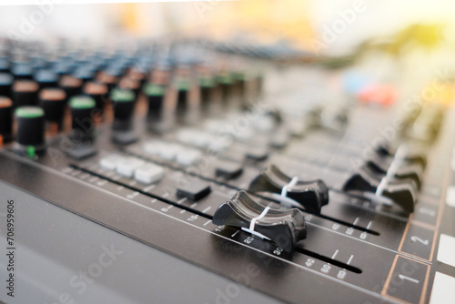 Mixing console in sound recording studio with shallow depth of field.