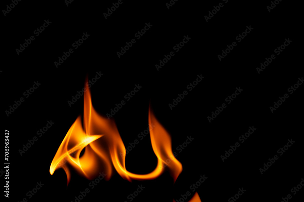 Hot flames on a black background. Beautiful flame of fire in the dark. Abstract of burning flames and smoke. Hot flames on a black background. Beautiful flame of fire in the dark. Abstract of burning flames and smoke.