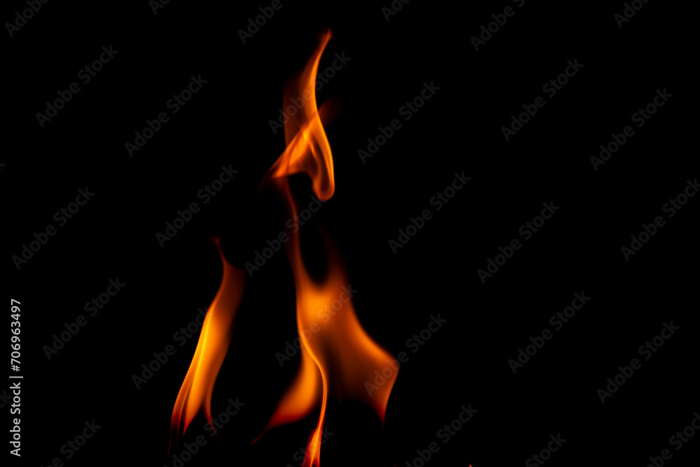 Hot flames on a black background. Beautiful flame of fire in the dark. Abstract of burning flames and smoke. Hot flames on a black background. Beautiful flame of fire in the dark. Abstract of burning flames and smoke.