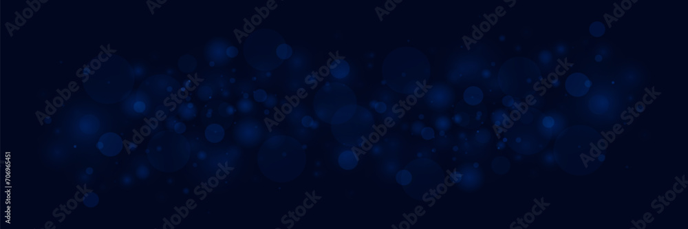 Blue bokeh background with defocused circles and sparkles. Light flare effect with dust particles.