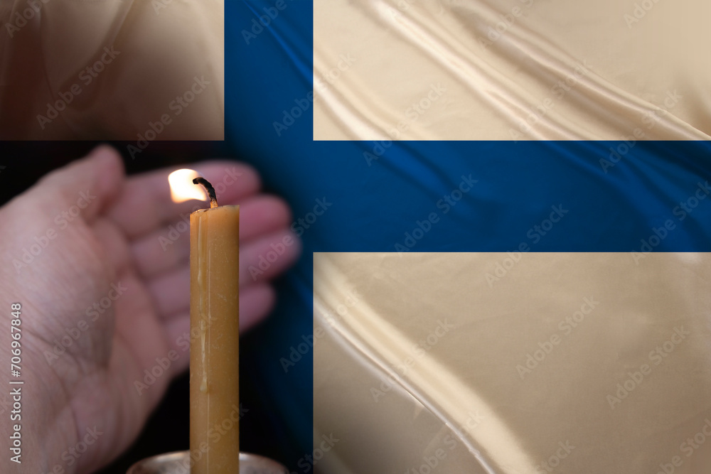 mourning candle burning front of flag Finland, memory of heroes served country, grief over loss, national unity in challenging times, state's history mourning candle burning front of flag Finland, memory of heroes served country, grief over loss, national unity in challenging times, state's history