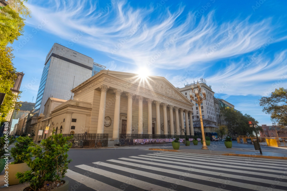Grand Neoclassical Building with Radiant Sunburst, Urban Pedestrian Crossing, and Cirrus Clouds