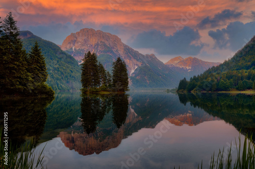 Golden Hour Serenity at Alpine Lake with Mirror Reflection, Majestic Mountains, and Vibrant Sunset Sky