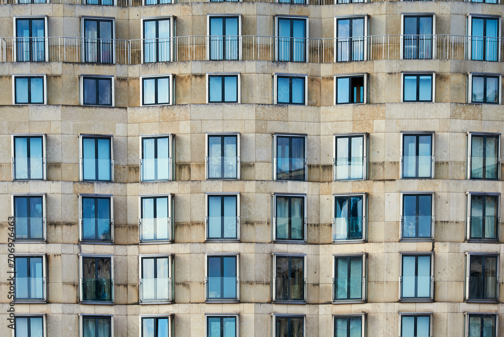 Front view pattern of windows or casement on a modern building. Contemporary exterior with pattern of fenestra or fanlight conveys rental crisis in all major capitals or real estate market concept Front view pattern of windows or casement on a modern building. Contemporary exterior with pattern of fenestra or fanlight conveys rental crisis in all major capitals or real estate market concept