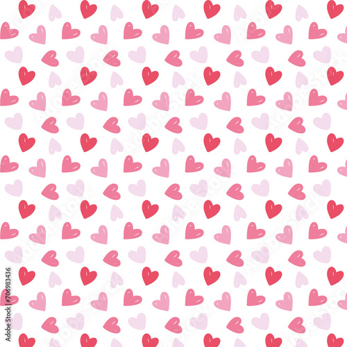 Seamless pattern of pink and red hearts spread on a white background