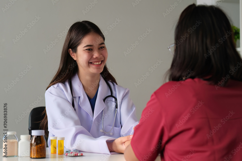 An Asian female doctor is consulting a patient who comes to discuss taking medication for health care. and treat disease with medicine An Asian female doctor is consulting a patient who comes to discuss taking medication for health care. and treat disease with medicine