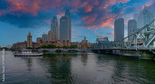 Serene Urban Dawn with Historic Clock Tower  Reflective Waterfront  and Iconic Bridge