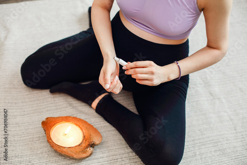 Calm pregnant woman using aromatherapy. Oil aromatic perfumes made of natural essential oils photo