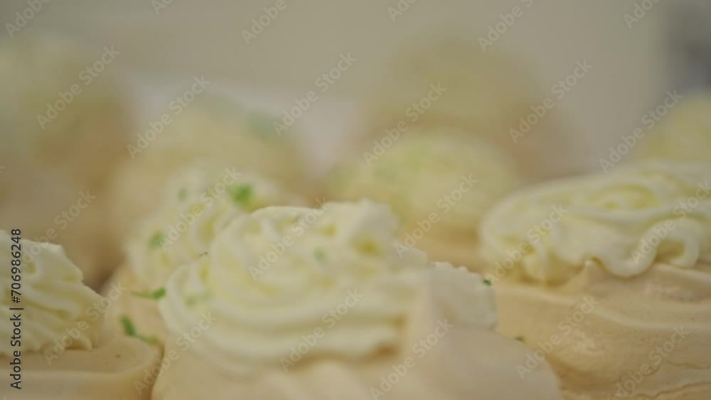 Mini Pavlova Cake Meringue Dessert With Whipped Cream and Grated Lime Mini Pavlova Cake Meringue Dessert With Whipped Cream and Grated Lime