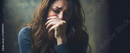 Depressed woman sitting in the dark photo