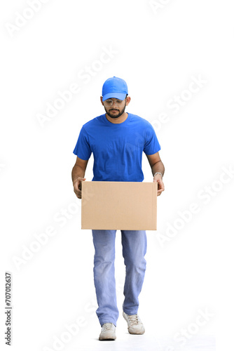 A male deliveryman, on a white background, in full height, puts a box © Katsiaryna