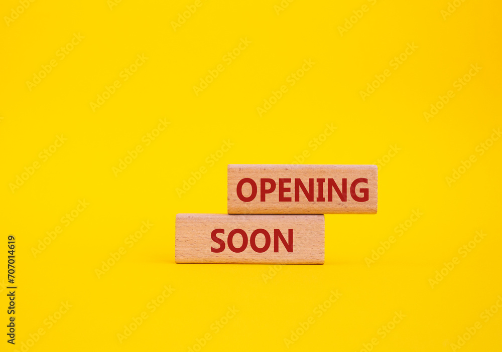 Opening soon symbol. Concept word Opening soon on wooden blocks. Beautiful yellow background. Business and Opening soon concept. Copy space Opening soon symbol. Concept word Opening soon on wooden blocks. Beautiful yellow background. Business and Opening soon concept. Copy space