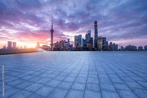 Empty square floor and modern city building landscape at sunrise in Shanghai
