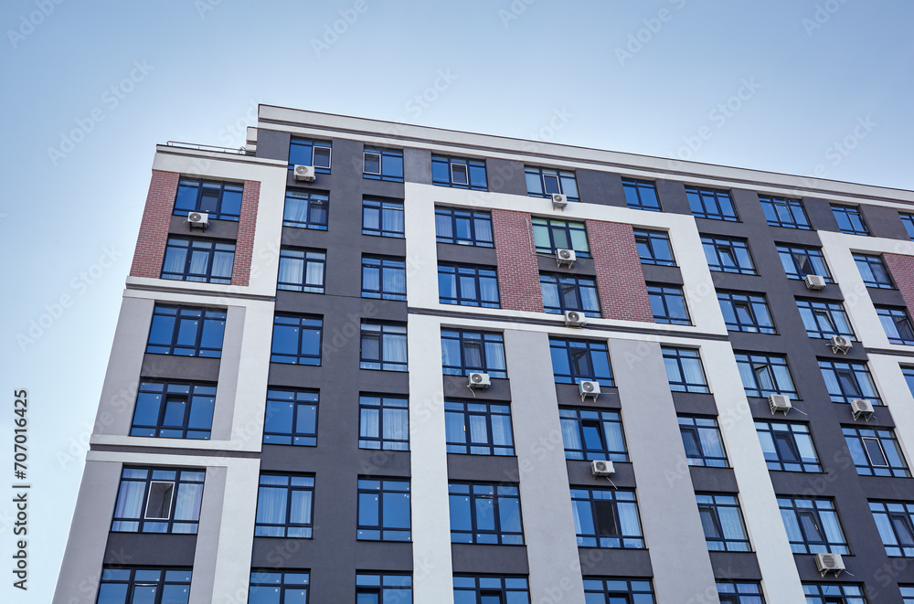 Modern apartment buildings on a sunny day with a blue sky. Facade of a modern European apartment building Modern apartment buildings on a sunny day with a blue sky. Facade of a modern European apartment building