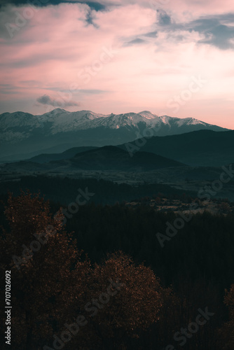Magical view of the sky with snowy mountains and moody foggy hill layers. © Ibrahim