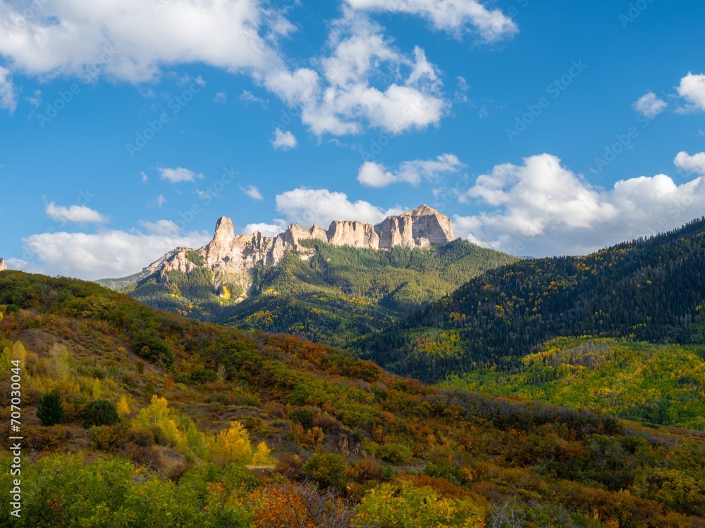 Fototapeta premium Scenic view of vibrant autumn trees on hills