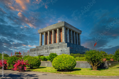 Imposing Mausoleum with Pillars, Red Flags, and Manicured Gardens at Dusk, Historical Monument Site