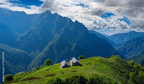 Traditional Stone Houses in Lush European Mountain Landscape, Serene Travel Destination with Majestic Peaks © Pixel Harmonics