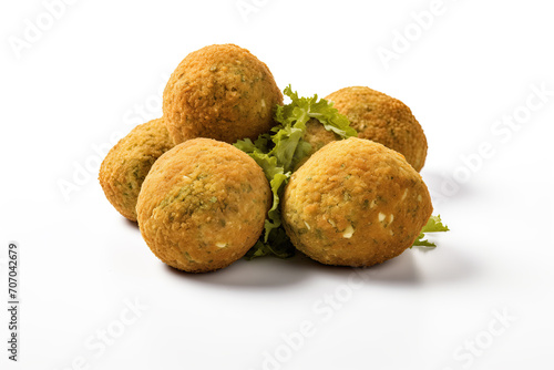 A close-up image showcasing a group of golden, crispy falafel balls garnished with fresh green herbs, isolated on a white background.