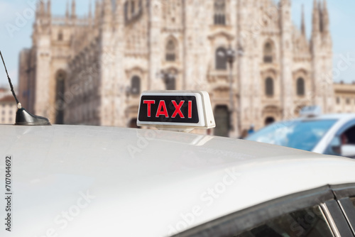 Taxi in Milan, Italy. Italian white taxi with sing on the roof.