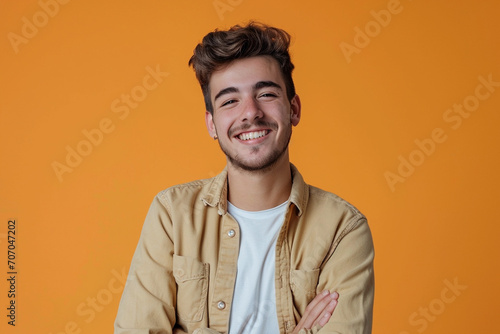 Fashion young man in studio giving pose on isolated color background © Madhulatha