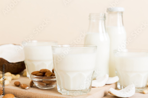 Set or collection of various vegan milk almond  coconut  cashew  on table background. Vegan plant based milk and ingredients  top view