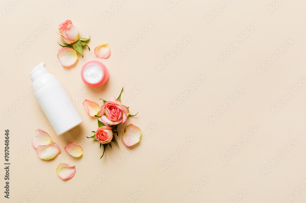 Fancy healthcare bottles for cream with rose flower. Natural oranic spa cosmetics concept. Mockup, template, Top view Fancy healthcare bottles for cream with rose flower. Natural oranic spa cosmetics concept. Mockup, template, Top view