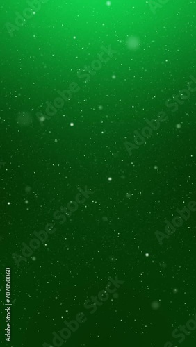 Snowfall with Green Background Loop. Snowflakes falling, green background, seamless loop and vertical resolution.