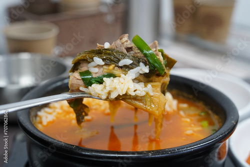 Beef rice soup is a spicy Korean food made by boiling Korean beef in the traditional way. photo