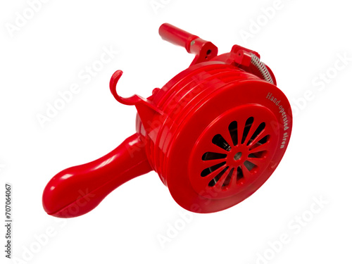 Hand operated siren, red, to signal an emergency, white background, isolated