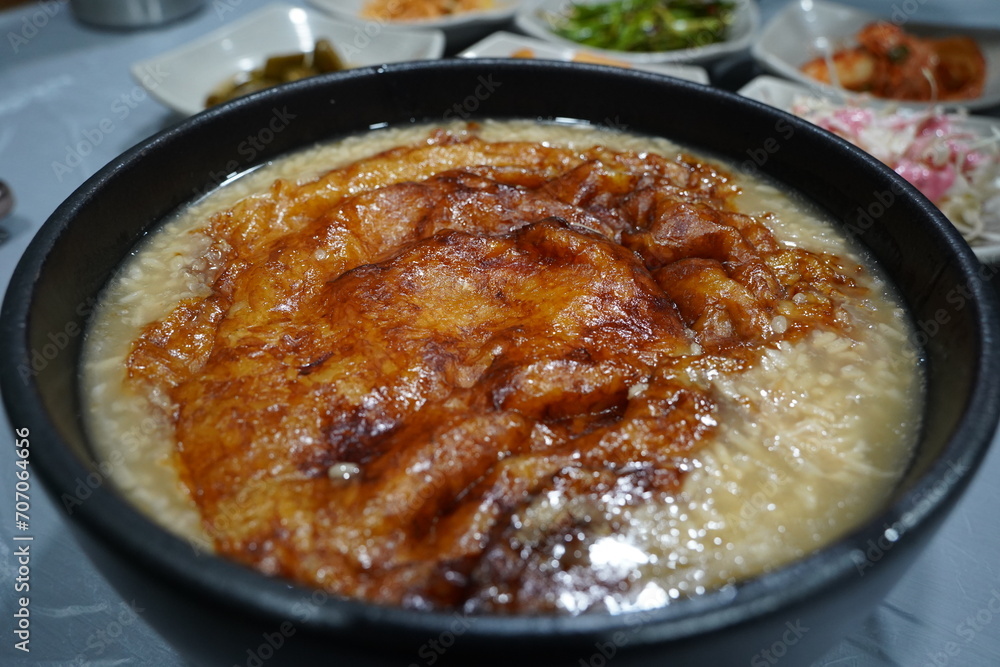 The thin crust of overcooked rice left at the bottom of a heated rice ...