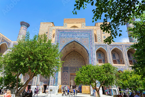 Inner courtyard of Ulugh Beg Madrasah with crowd of tourists. Registan square. April 24, 2023. Samarkand, Uzbekistan