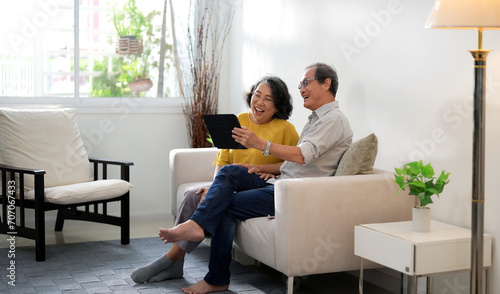 Elderly Asian couple spends a relaxing time together at home, Happy life retirement. photo