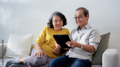 Elderly Asian couple spends a relaxing time together at home, Happy life retirement.