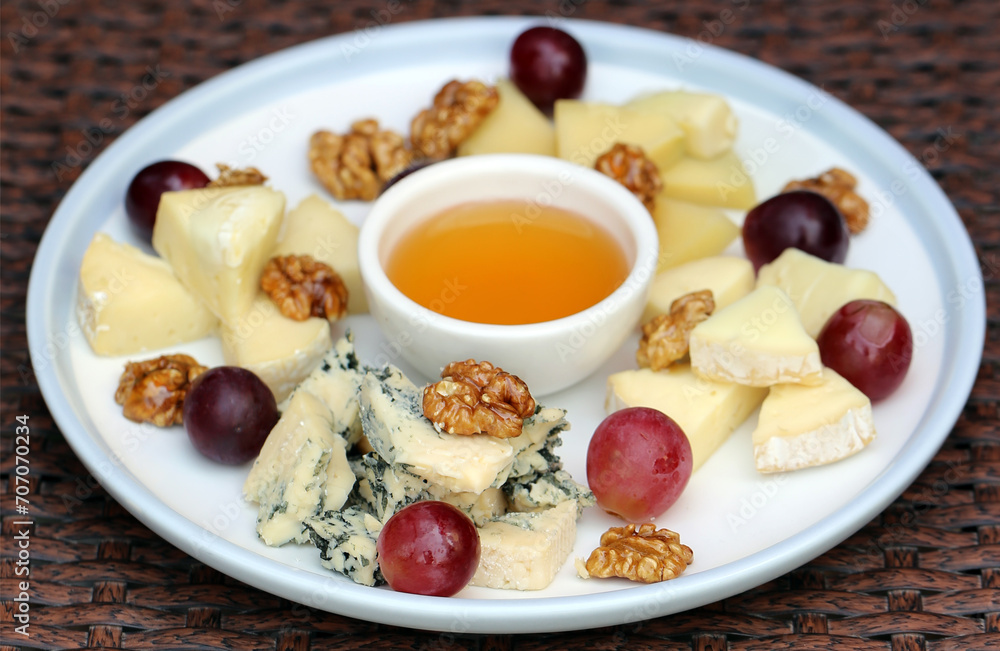 cheese plate with grapes and honey