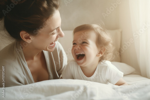 Joyful moment between mother and child laughing together in a bright, cozy bedroom, radiating love and happiness