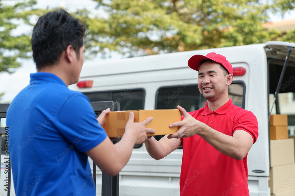 Fototapeta premium small business Independent company owners, couriers pack boxes of online orders for delivery. Handing a box to a customer, SME business concept, service.