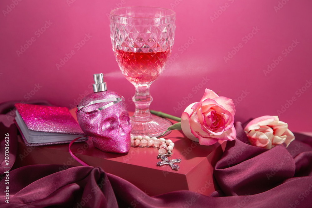 pink still life with perfume bottle in form scull and glass of wine pink still life with perfume bottle in form scull and glass of wine