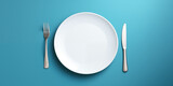 empty white plate with cutlery.  isolation on a blue background