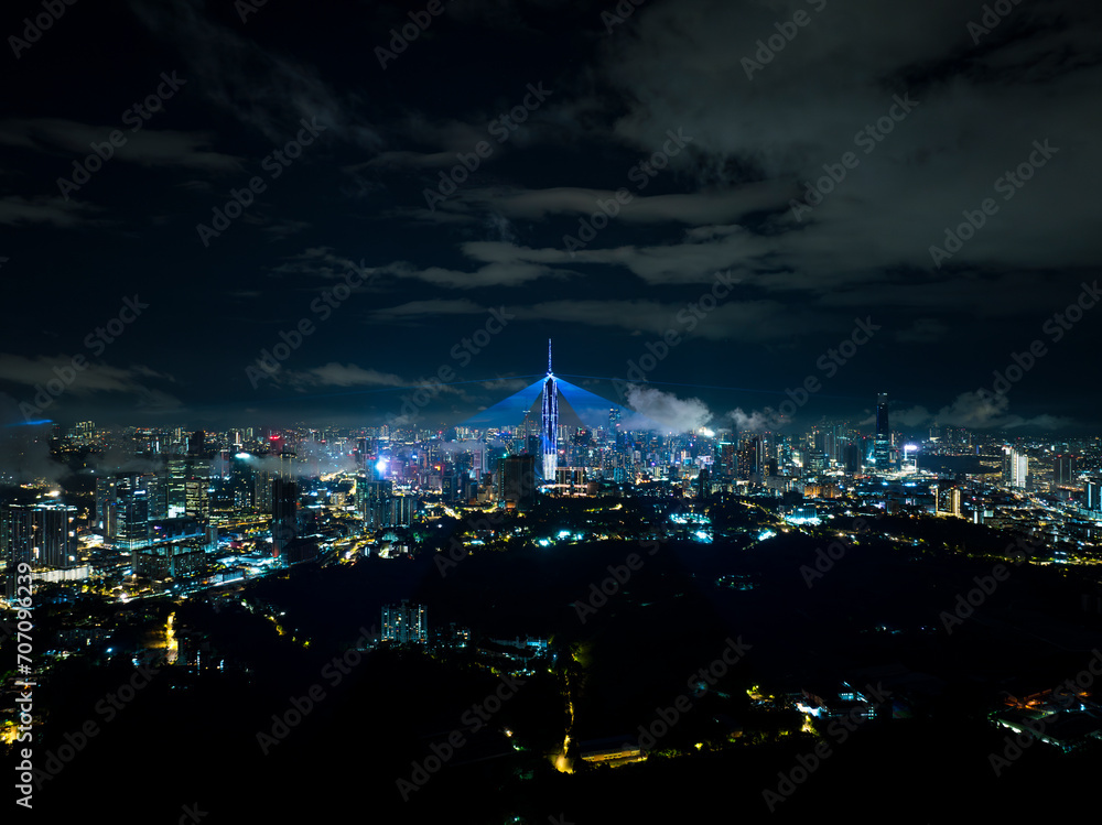 An high angle aerial view of the tallest Skyscrapper in south east asia during night with colorful light and laser show