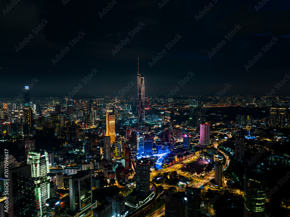 An high angle aerial view of the tallest Skyscrapper in south east asia during night with colorful light and laser show
