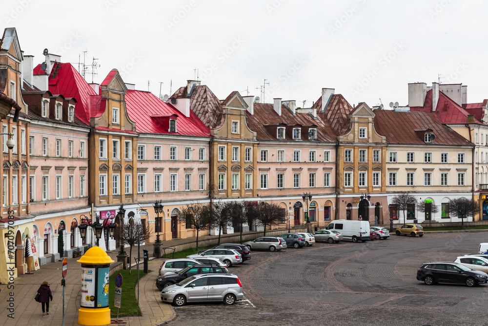 Lublin, Poland - 25 December 2019: Colorful houses in the beautiful old city of Lublin at Christmas and cars on the parking lot