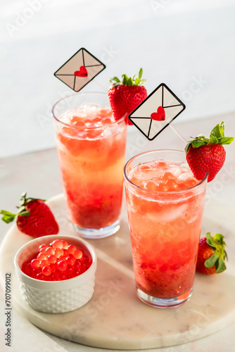 Glasses of fresh strawberry lemonade with bubble pearls, for Valentine's Day.
