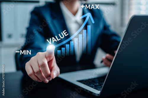 Businesswomen pointing virtual value arrow graph raises for business and profit to benefit growth organization, the business added value, potential skill labor, stock valuation. photo