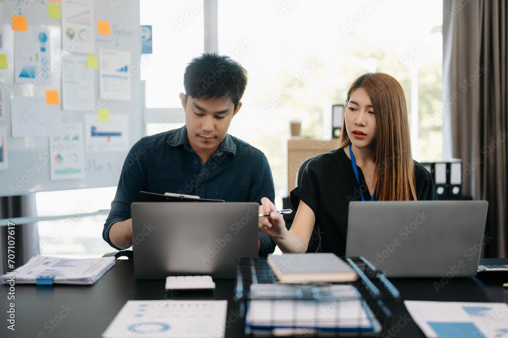 Furious two Asian businesspeople arguing strongly after making a mistake at work in office.. Furious two Asian businesspeople arguing strongly after making a mistake at work in office..