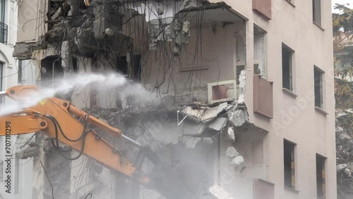 4K Construction Building - Demolition digger destroying an old building - Demolition of apartment block - Medium shot of house being demolished - Building demolition with scoop - Disintegration