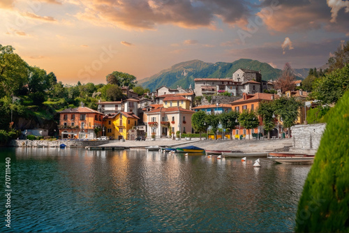 Golden Hour Serenity at a Tranquil European Lakeside Village with Moored Boats, Italy photo