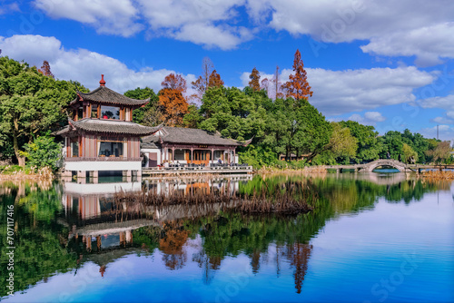 Traditional East Asian Architecture and Autumn Scenery Reflected in Calm Waters  Serene Park Scene