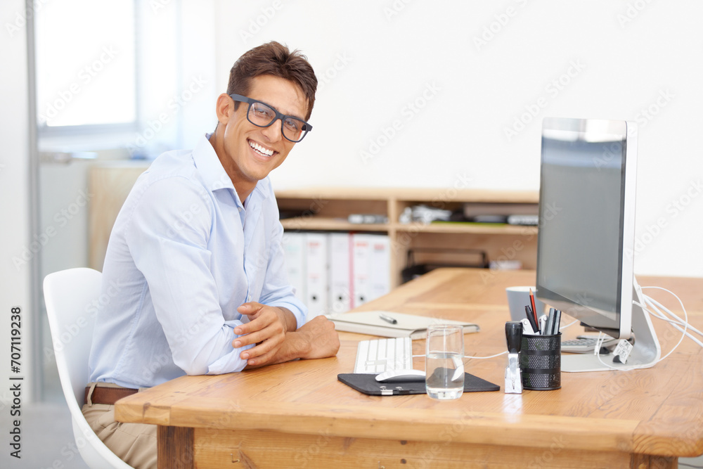 Fototapeta premium IT support, portrait or happy man with computer at desk with information for web design or solution. Smile, business or employee programming with glasses or research online on screen on pc in office