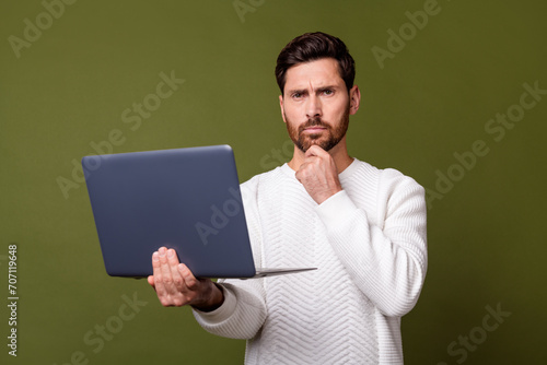 Photo of successful serious man wear trendy white clothes hold modern gadget wireless netbook isolated on khaki color background © deagreez